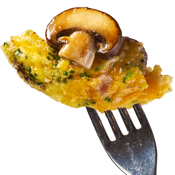 A bite of mushroom egg bites featuring crimini mushrooms on the tip of a fork